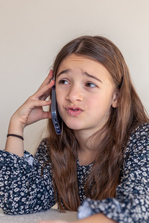 A girl with a phone. The girl is talking on the phone.の写真素材
