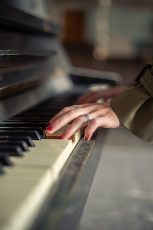 Female hands on piano close-up. Female hands playing the piano.