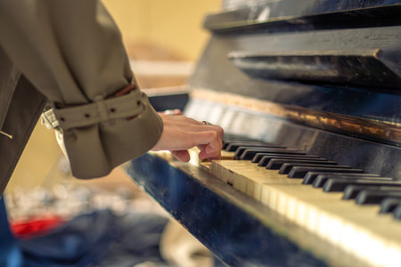 Female hands on piano close-up. Female hands playing the piano.の写真素材