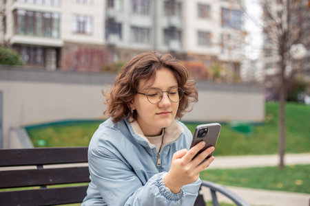 Teenage girl with a phone. Teenage girl in the city. Life in the city.の写真素材
