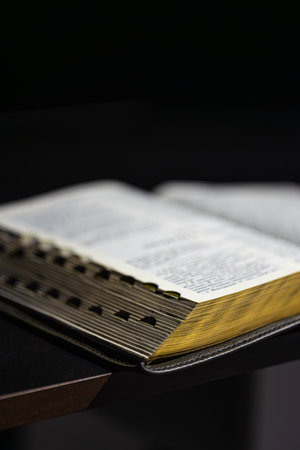 Open Bible on a black background. Religion concept.の写真素材