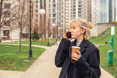 Young attractive woman in the city talking on the phone. Woman in the city.の写真素材