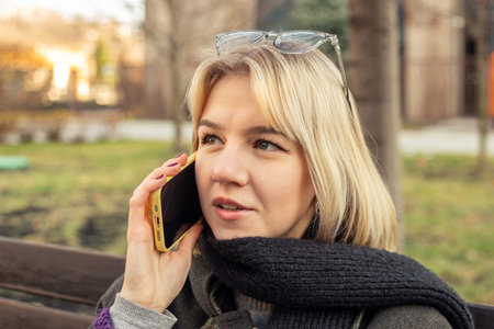 Young beautiful woman talking on the phone in the city. Woman in the city.の写真素材