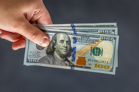 Hand holding money. International currency. Exchange world money.の写真素材