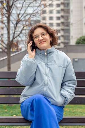 Young woman talking on the phone in the city.の写真素材