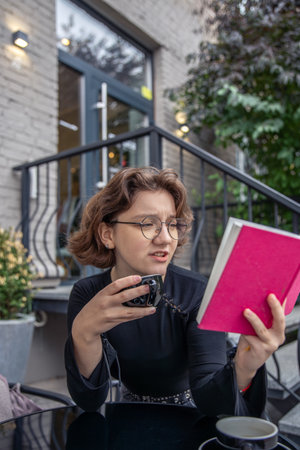 A young woman is carefully reading a book. Emotion concept.の写真素材