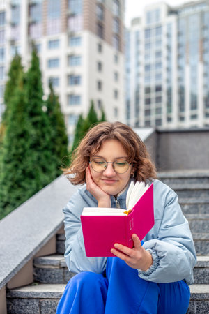 Girl reading a book close-up. Teenage girl reading a book.の写真素材