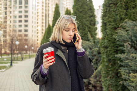 Young beautiful woman talking on the phone in the city. Woman in the city.の写真素材