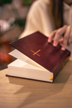 Bible close-up. Christianity concept. Reading the Holy Bible. Bible in womens hands.の写真素材