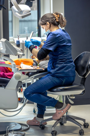 Young female dentist in dental office. Dentist at work. Dental treatment concept.の写真素材