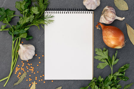 Cooking ingredients with blank notebook. Open recipe book with herbs and spices.の写真素材