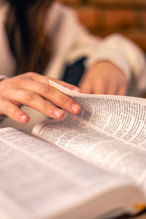 Bible close-up. Christianity concept. Reading the Holy Bible. Bible in womens hands.の写真素材
