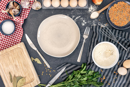 Flat lay cooking ingredients and empty plate. Background with cooking ingredients.の写真素材