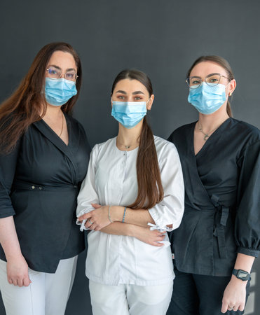 Attractive women dentists in masks. Dentistry concept. Portrait of happy women.