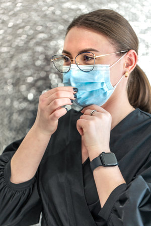 Portrait of a young female dentist in a mask. Dentistry concept. Dental treatment.の写真素材
