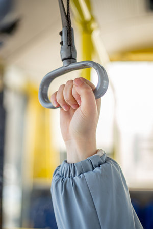 Public transport. Hand holding on to the handrail. Travel by bus.