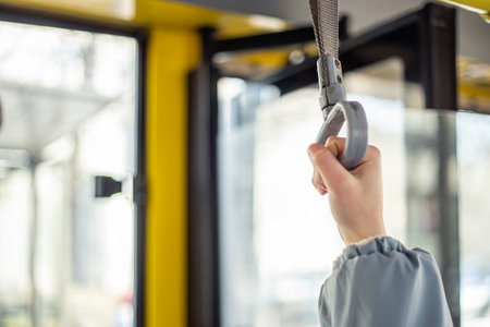Public transport. Hand holding on to the handrail. Travel by bus.の写真素材