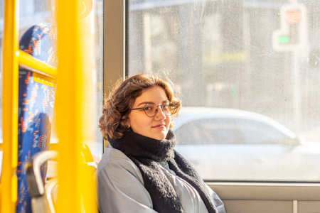 A female student rides public transport. Public transportation and people concept.