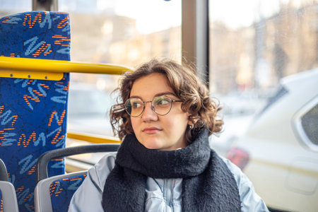 A female student rides public transport. Public transportation and people concept.の写真素材