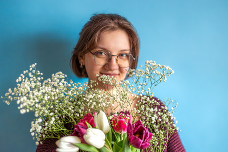 Young woman with a bouquet in her hands. Womens Day. Valentines Day.の写真素材