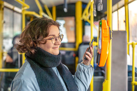 Young woman paying for public transport. Public transport.の写真素材