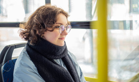 A female student rides public transport. Public transportation and people concept.の写真素材