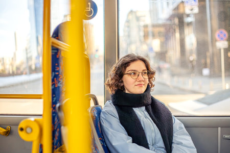 A female student rides public transport. Public transportation and people concept.の写真素材