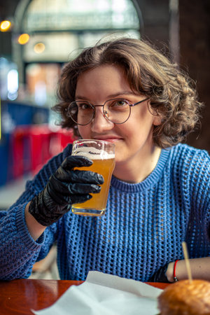 Young woman eating burger. Fast food. A woman in a burger restaurant.の写真素材