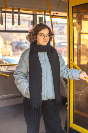 Young woman holding on to handrail in public transport. Public transport.の写真素材