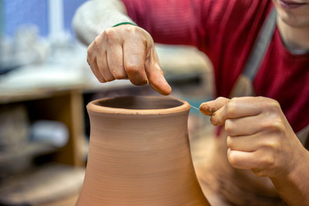 A male potter is making a vase. Pottery. Clay modeling. Making ceramics.の写真素材