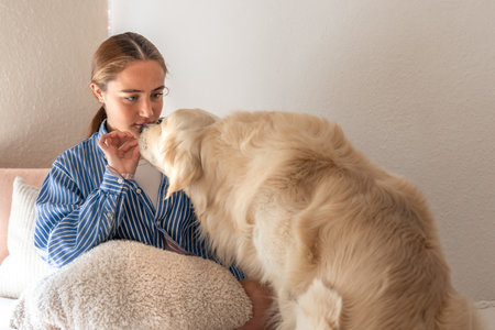 Cute teenage girl with a dog. Pet. Girl playing with her pet dog at home.の写真素材