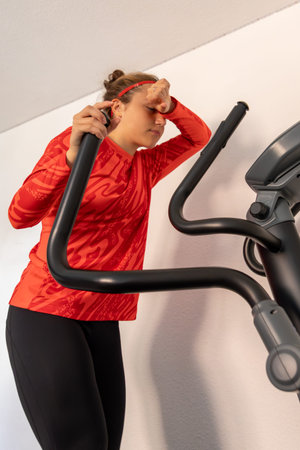 Sporty girl training on a treadmill at home. Home workout. Treadmill.