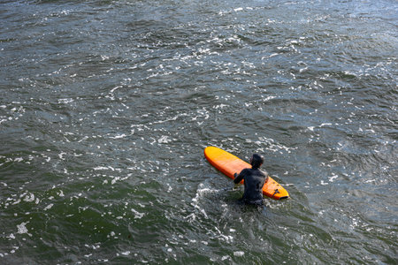 Male surfer on a surfboard. Surfer on a surfboard on a sea wave. Ocean. Surfing.の写真素材