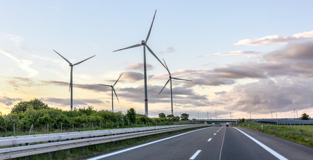 Wind turbines along road. Wind generation. Eco landscapeの写真素材