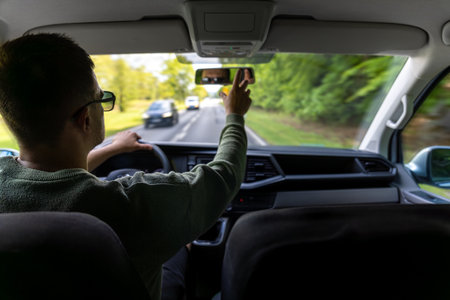 Spring car trip. Driver in motion. Front seat view.の写真素材