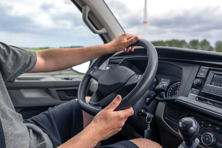 Hands on steering wheel. Driving interior. Safe car ride.