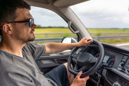 Road trip driving. Man with sunglasses. Steering car on highway