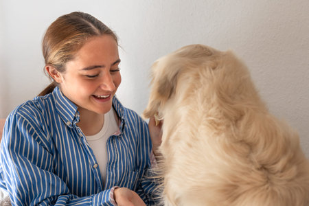 Cute teenage girl with a dog. Pet. Girl playing with her pet dog at home.