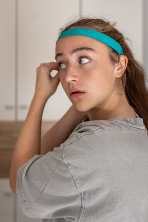 Girl with a sports headband. Preparation for sports exercises. Sports concept.の写真素材