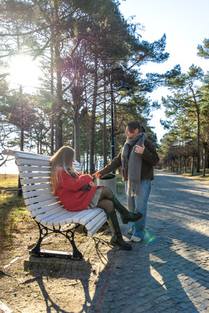 Two women sitting on a park bench. Park. Two women spending time together.の写真素材
