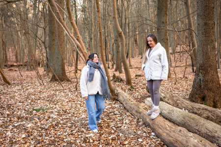 Two female friends on a walk in the forest. Friends walking through the forest. People in nature.の写真素材