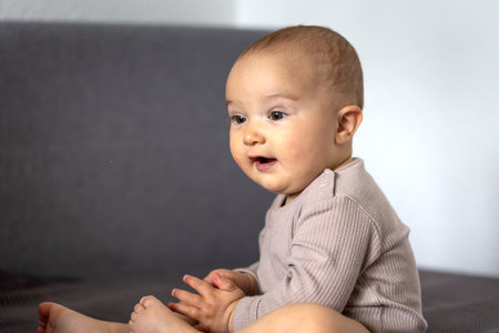 Happy baby. Child on bed. Infant portraitの写真素材
