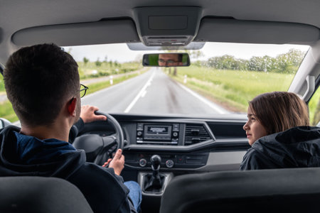 Driver behind the wheel. Front seat passenger. Road trip