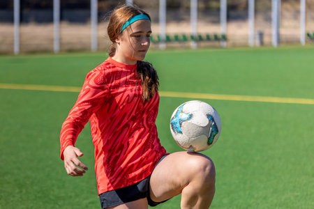 Girl on the soccer field. Soccer training. Active lifestyle. Football concept.の写真素材