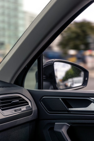 Car mirror from inside. Urban city background. Interior driving view.
