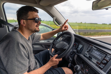 Driver gesturing. Driving a car. Highway travel.