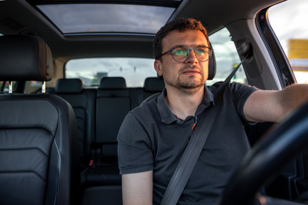 Man driving car. Driver in modern vehicle. Safe driving concept.の写真素材