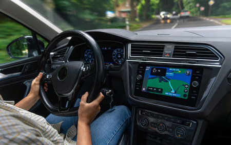 Female driver in urban motion. Car interior with navigation. Driving lifestyle