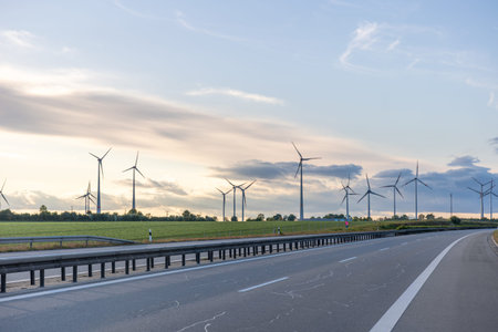 Highway and wind turbines. Sustainable infrastructure. Clean energy.