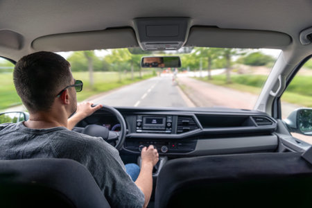 Urban road trip. Car interior. Focused driver.の写真素材